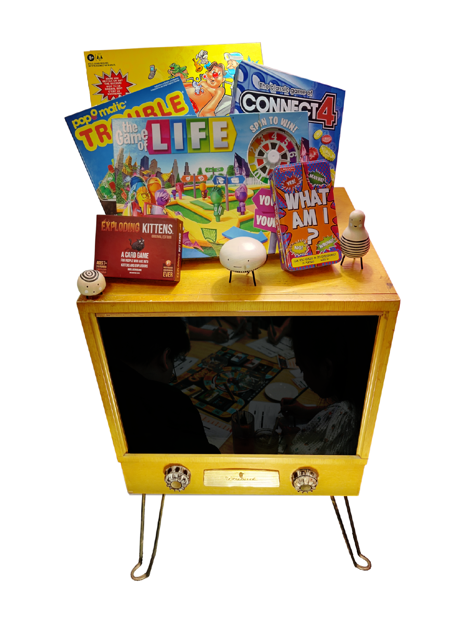 Old television featuring a collection of kids' board games resting on top. Reflection in tv shows group of kids  playing games.